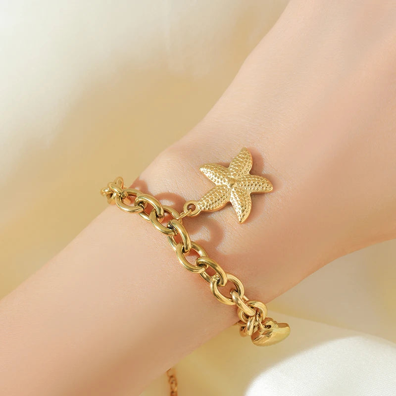 Bracelet Velora – Étoile de Mer & Lune Dorée
Laissez-vous séduire par ce bracelet délicat orné de charms étoile de mer, lune et étoile. Sa finition dorée élégante apporte une touche de poésie et de raffinement à